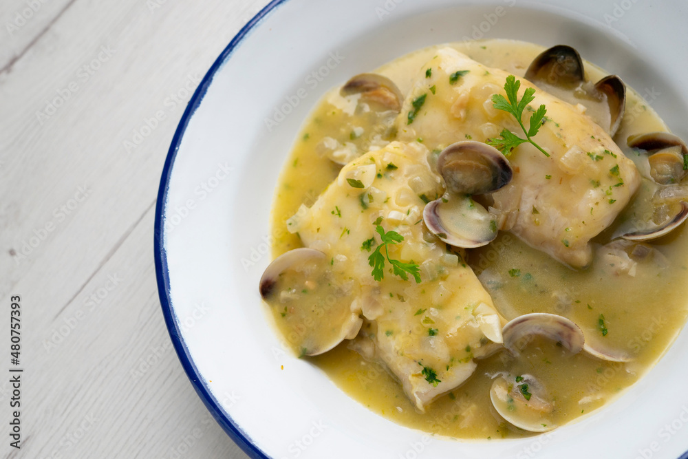 Hake in green sauce with parsley and clams. Traditional Spanish recipe. Hake in green sauce with parsley and clams. Traditional Spanish recipe.