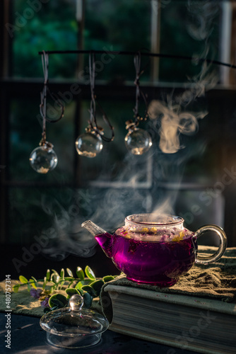 Violet tea still life with window and witchy magic atmosphere