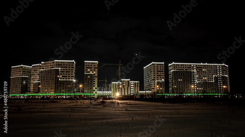 New residential complex with lighting and warm illumination at night