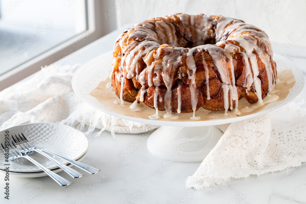 An apple cinnamon pull apart coffee cake drizzled with icing, ready for  serving. Stock Photo | Adobe Stock