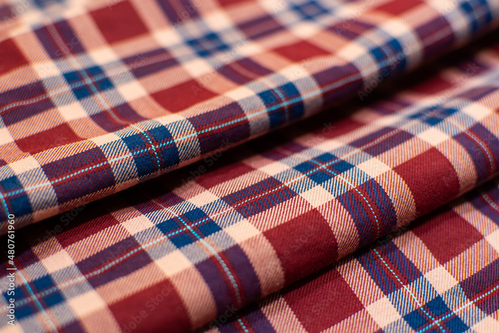 background of red cotton fabric with a checkered pattern background of red cotton fabric with a checkered pattern