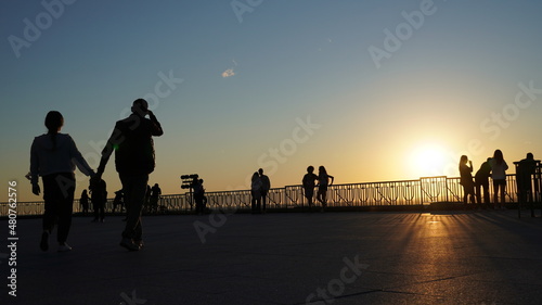 silhouettes of people walking on roof of Saint Joseph;s Chruch. #people #silhouette