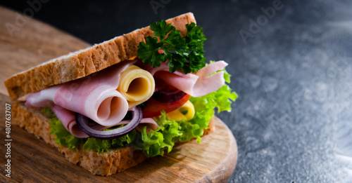 Sandwich with cheese and ham and fresh vegetables