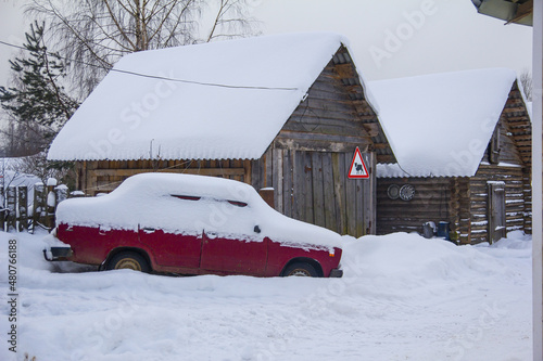 snow covered red car