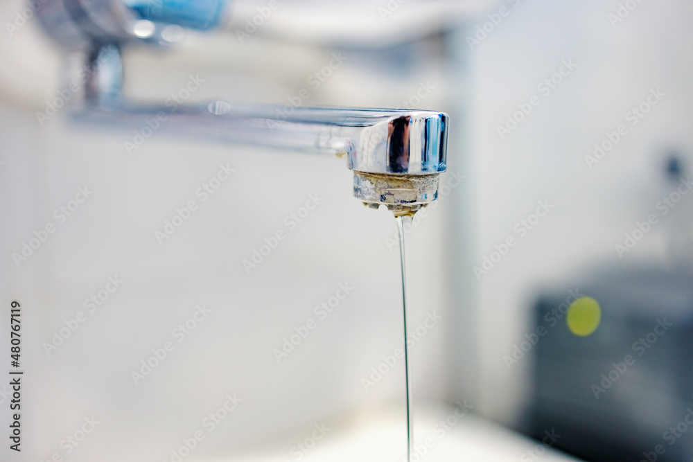 Calcified water. Close up of a limescale tap with calcified and polluted water. Calcified water. Close up of a limescale tap with calcified and polluted water.
