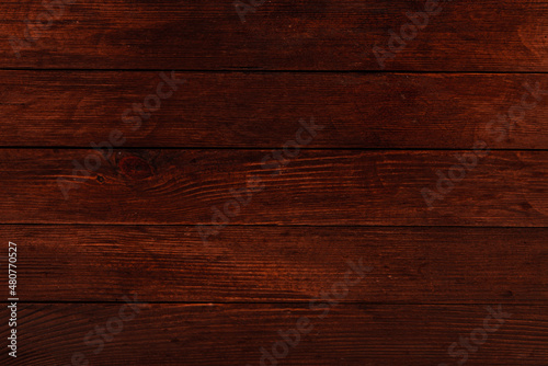 Vintage brown wood background texture with knots and nail holes. Old painted wood wall. Wooden dark horizontal boards