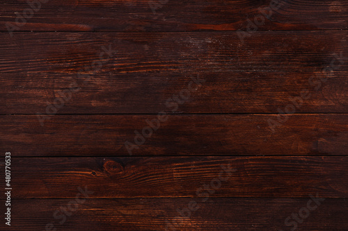 Vintage brown wood background texture with knots and nail holes. Old painted wood wall. Wooden dark horizontal boards