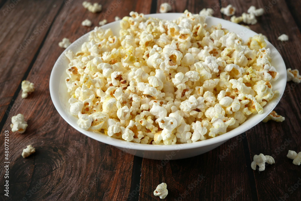 tasty popcorn in a white bowl top view tasty popcorn in a white bowl top view