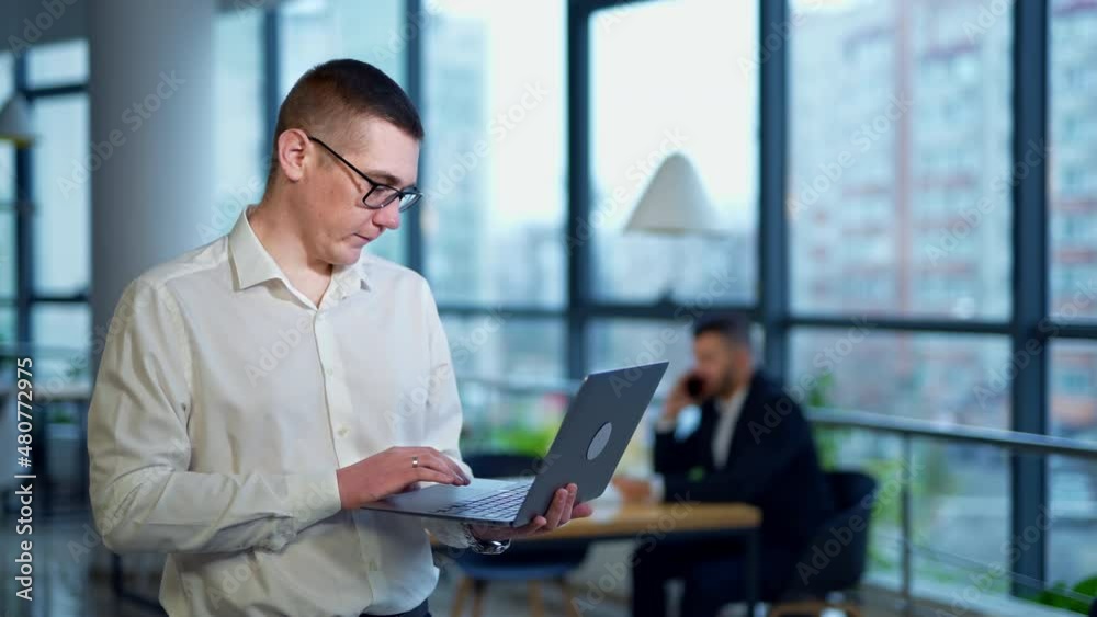 Handsome businessman working in the modern office. Young confident smart office worker. Handsome businessman working in the modern office. Young confident smart office worker.