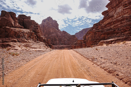 view of the road and mountains in the Wadi Rum desert from the top of the car roof, Jordan  