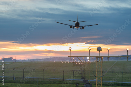 Poland, Krakow, Balice Airport, Aircraft Landing against Sunset