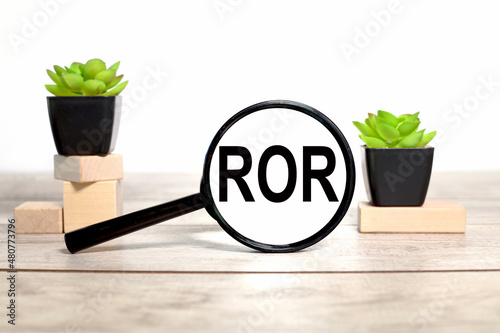 ROR. magnifier with place to insert text. on wooden background.business concept photo