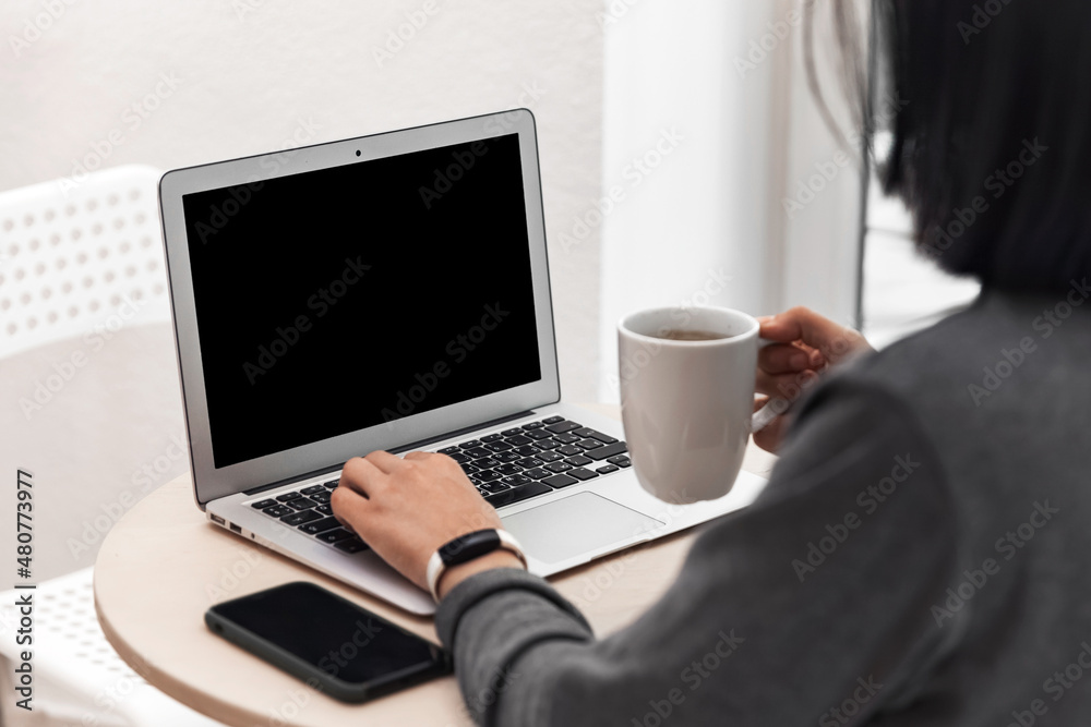 Woman typing on laptop with black screen, closeup photo Woman typing on laptop with black screen, closeup photo