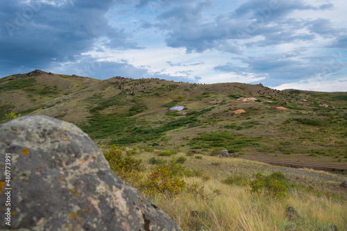 Summer landscape. Green hills and dramatic sky. Nature concept