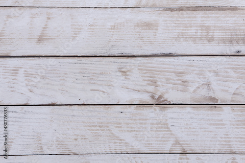 Vintage white wood background texture with knots and nail holes. Old painted wood wall.