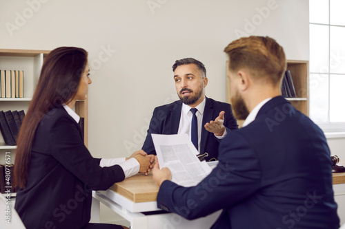 Fotografie Family lawyer in suit speaking to clients