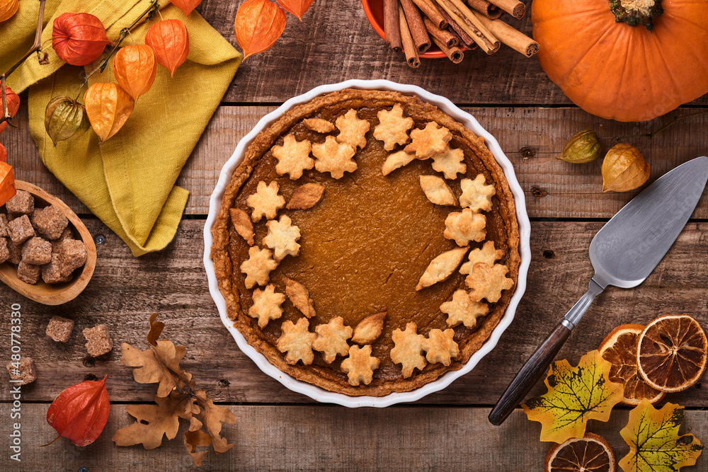 Pumpkin Pie. Tart with whipped cream and cinnamon on rustic background. Traditional american homemade pumpkin cake for Thanksgiving or Halloween Ready to eat. Mock up.