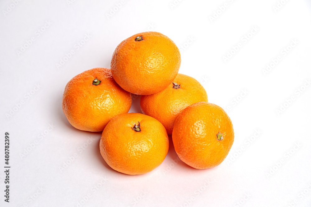 Several tangerines on a blue background. Several tangerines on a blue background.