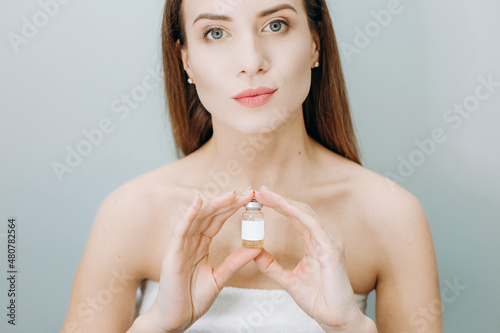 woman insistently approves buy bottle medicine cosmetic photo