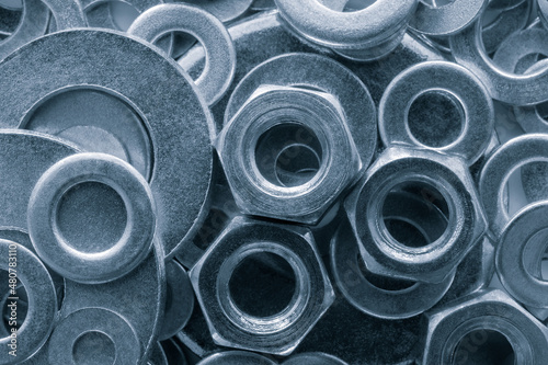 Billede på lærred Abstract industrial textured metal background with many metal washers for bolts