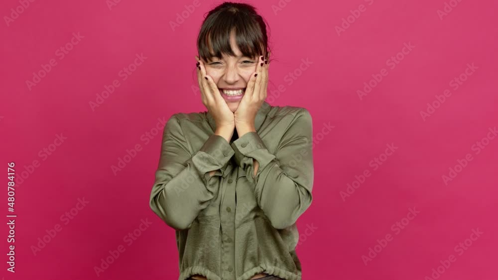 Pretty woman celebrating a victory and surprised to be successful over isolated background Pretty woman celebrating a victory and surprised to be successful over isolated background