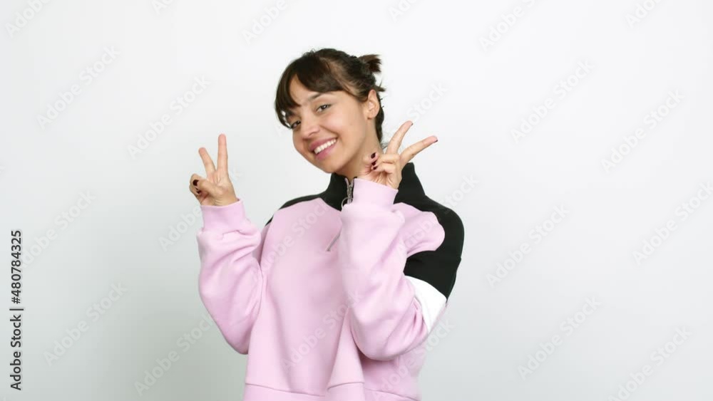 Pretty woman smiling and showing victory sign with a cheerful face over isolated background Pretty woman smiling and showing victory sign with a cheerful face over isolated background