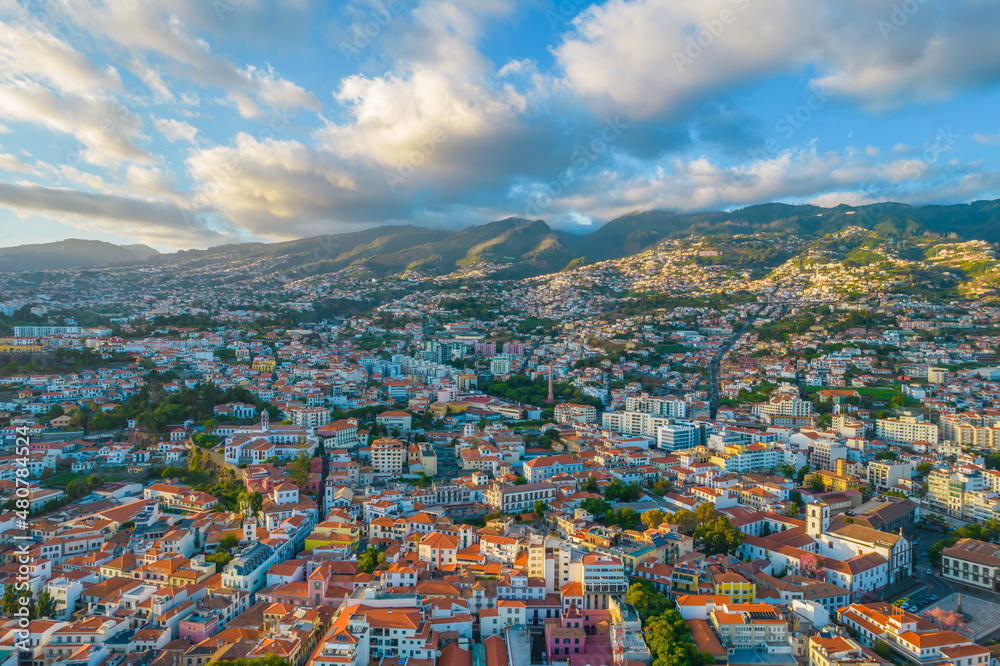Aerial drone view of Funchal city center panorama in Madeira island in the evening. It's Portugal's Autonomous Region and is located in Atlantic ocean