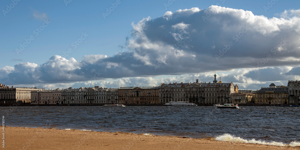 Neva River in autumn on windy day with beautiful clouds over the Palace Embankment.