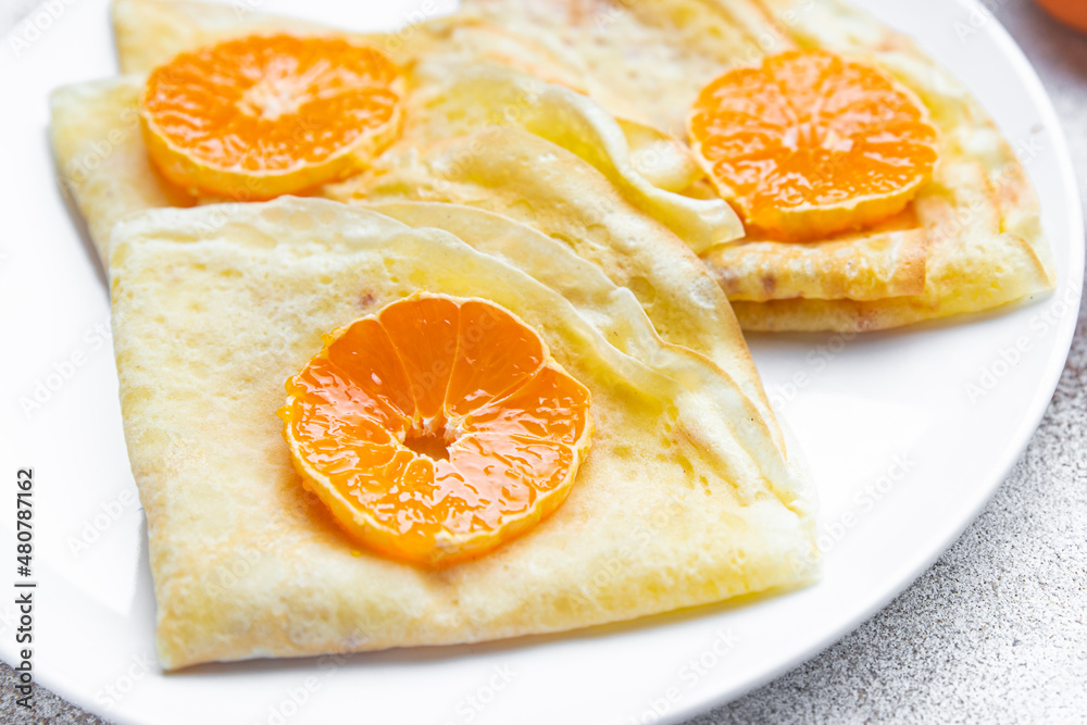 crepes citrus thin pancakes sweet dessert tangerine or tangerines breakfast healthy meal food snack on the table copy space food background rustic top view