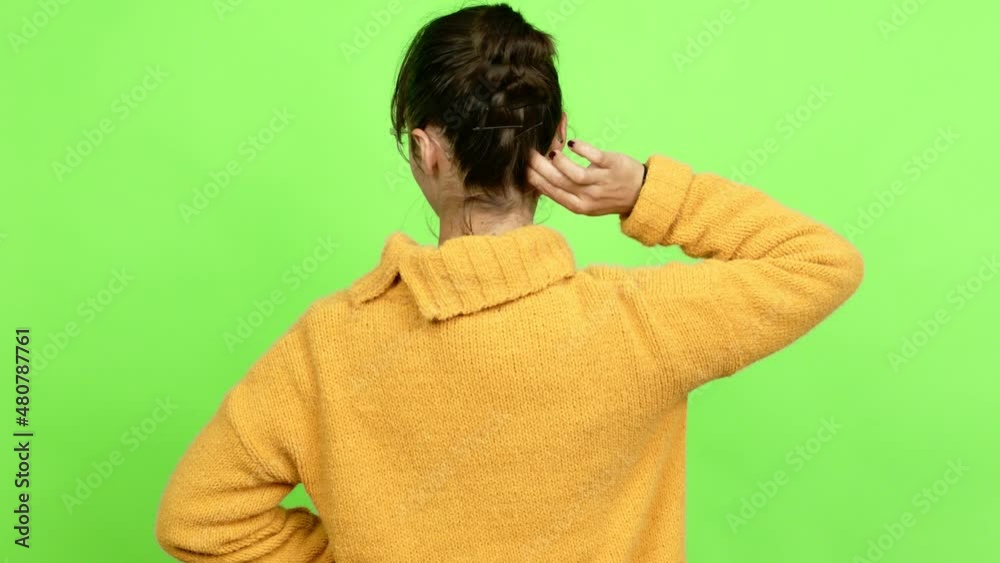 Pretty woman on back position looking back while scratching head over isolated background. Green screen chroma key Pretty woman on back position looking back while scratching head over isolated background. Green screen chroma key