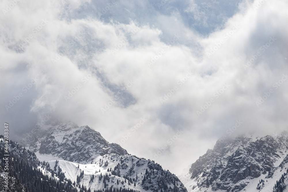 Amazing rocky mountains merge with the clouds landscape