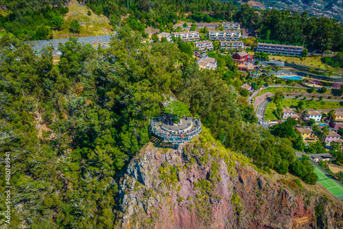 Aerial view of Cabo Girao - a lofty sea cliff located along the southern coast of the island of Madeira. The observation view balcony with glass floor with the elevation of 580m photo