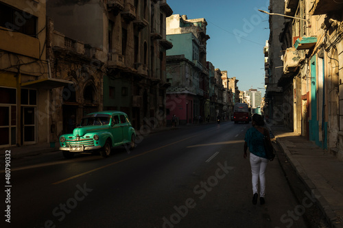 Amazing old american car on streets of Havana with colourful buildings in background. Havana, Cuba.