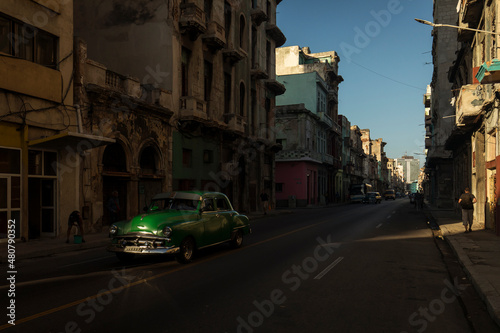 Amazing old american car on streets of Havana with colourful buildings in background. Havana, Cuba. © danmir12