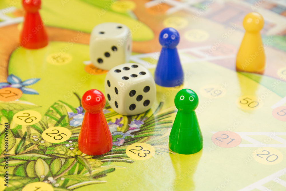 Colorful play figures with dice on board