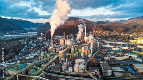 Foto Aerial view of a huge paper factory facility in Austria during sunset