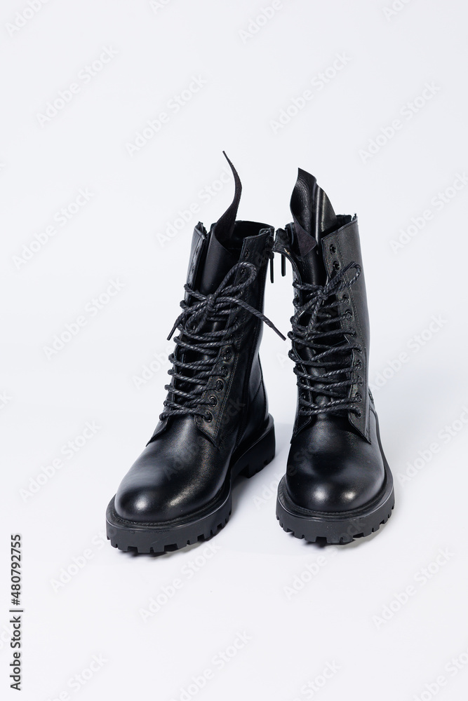 Black women's leather lace-up boots from the new collection on a white background from leather autumn-winter 2022. Boots close-up
