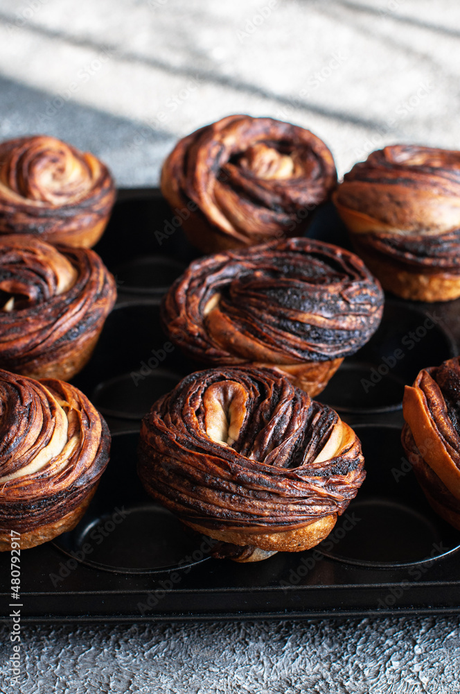 Chocolate cruffin, a hybrid of a croissant and muffin with a lot of butter, sprinkled with powdered sugar. Chocolate cruffin, a hybrid of a croissant and muffin with a lot of butter, sprinkled with powdered sugar.