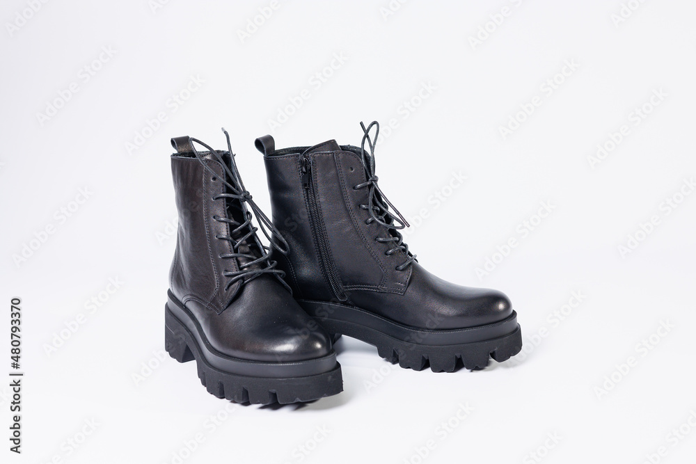 Women's black leather boots on a white background. Shoes and options for its layout. Autumn shoes. Boots. Autumn boots. Shoes close up