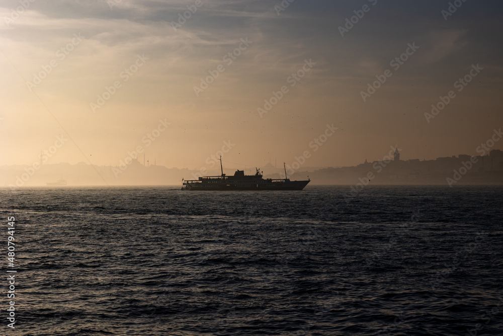 Istanbul. Cityscape of Istanbul and ferry on the bosphorus at foggy weather
