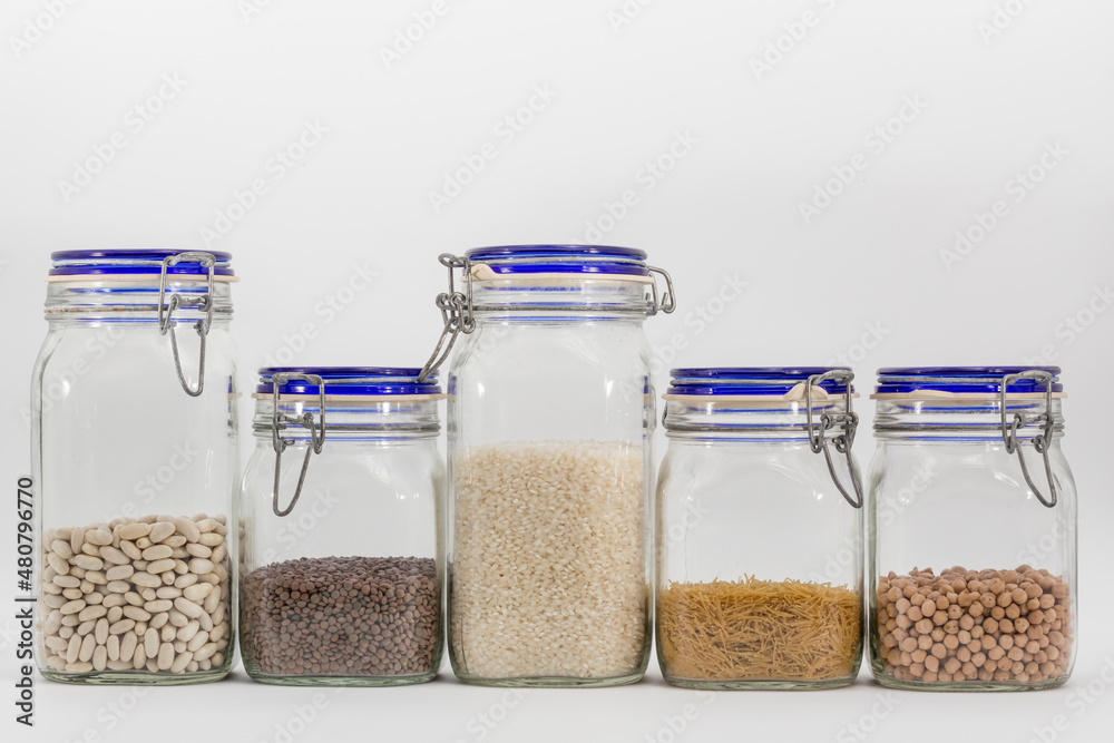 pantry jars with raw food, on white background