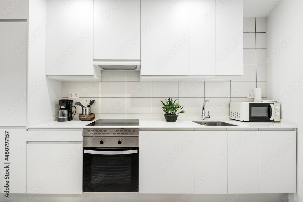 wall covered with white kitchen furniture with white silestone countertop and rectangular tiles wall covered with white kitchen furniture with white silestone countertop and rectangular tiles