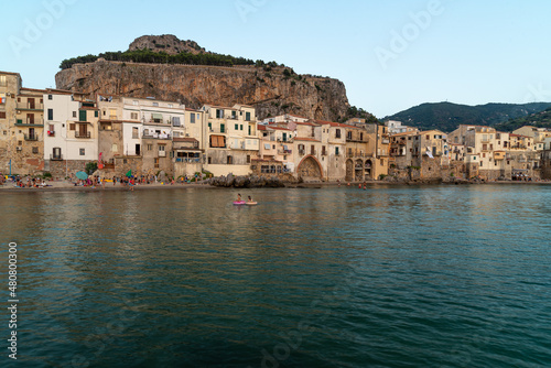Fototapeta Naklejka Na Ścianę i Meble -  Scenic view of Cefalu town in Siciliy at sunset with sea bathers tourists
