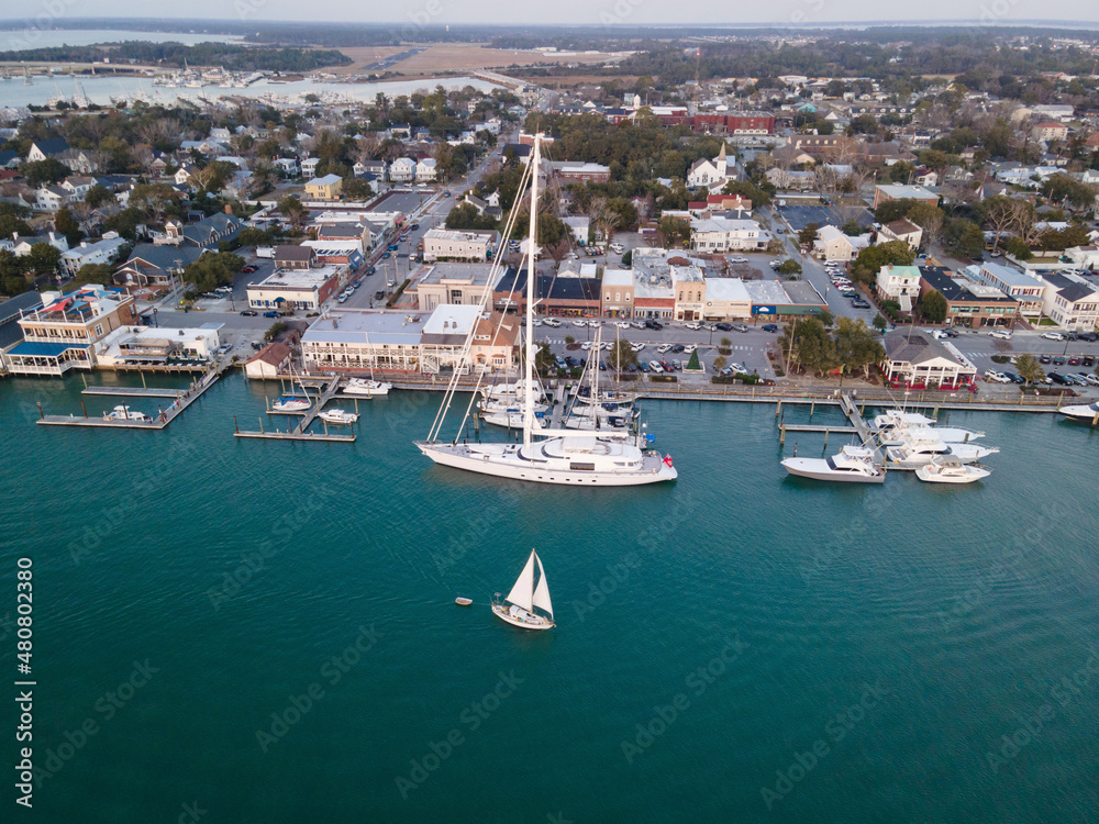 Aerial View of Superyacht and Sailboats Along Waterfront in Beaufort, North Carolina