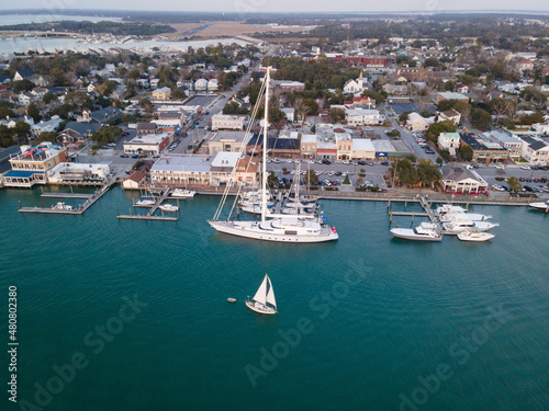 Aerial View of Superyacht and Sailboats Along Waterfront in Beaufort, North Carolina