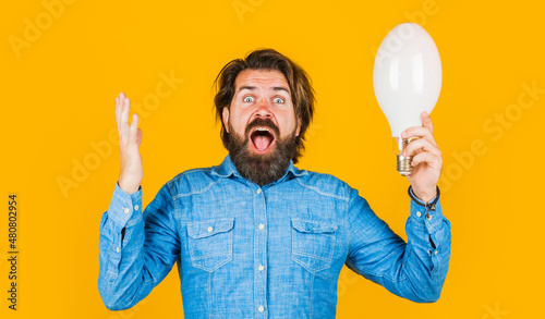Good idea. Surprised man with big lamp. Bearded male with light bulb. Solution and decision.