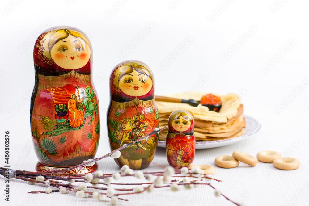Ταπετσαρία Background with pancakes, wooden dolls matryoshka, sushki and spoon with red caviar on white for Maslenitsa festival