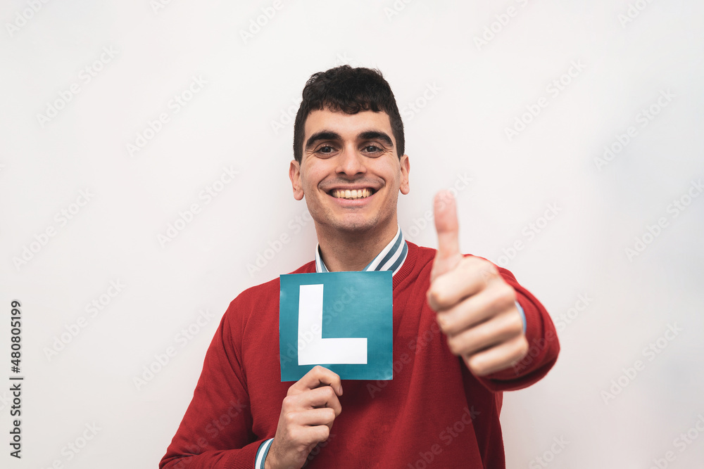 a smiling boy holding up an a smiling boy holding up an