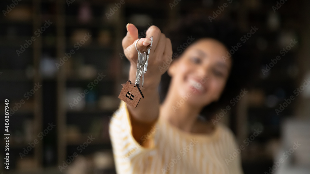 Αυτοκόλλητο Close up focus on keys in hands of smiling young African American woman, celebrating moving into rental apartment