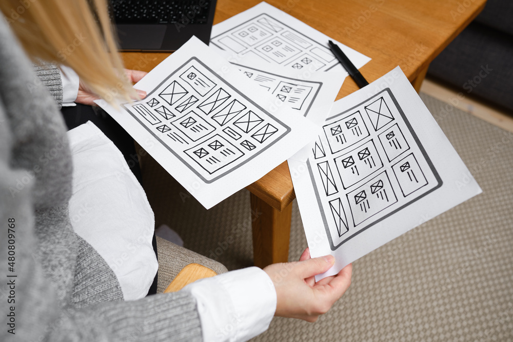 Naklejka premium Woman designer create website design wireframe. Sketch, prototype, framework, layout future design project. UI and UX - user interface, user experience designer. Creative concept for web design studio